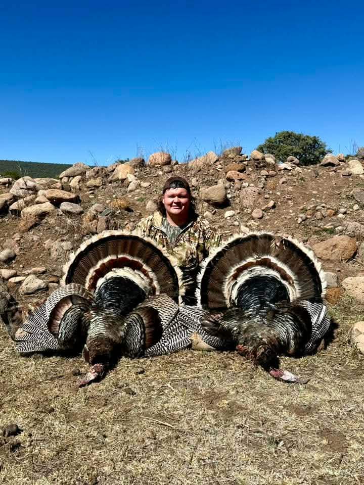 image of hunter with 2 trophy Goulds Turkeys